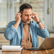 © Miljan Živković - Man wearing headset, working remotely from home office