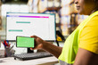 © DC Studio - Warehouse worker in a hi-vis vest uses copy space display with technology of shipping software, packaging systems and inventory management tools. automation in e-commerce logistics.