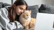© Johannes - young hispanic latin teen girl student relax sit on sofa with cat holding laptop looking at mock up white computer screen online learning on pc elearning watching movie over shoulder closeup view no