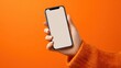 © Johannes - close up of woman hand using smartphone isolated on orange wall female hands showing empty white screen of modern smart phone businesswoman holding cellphone and unlocks it with her fingerprint no lo