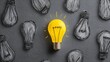 © sungedi - One illuminated light bulb stands out from many unlit, sketched bulbs.