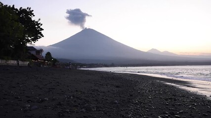 Wall Mural - Dramatic 2018 footage of Mount Agung’s volcanic eruption from Amed Beach, Bali, showing ash plumes, coastline views, and one of Indonesia’s most iconic active volcanoes.