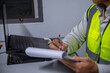 © akarapon - A skilled engineer is seriously planning a warehouse expansion for a large manufacturing plant.