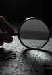 © Kind Bee Studio - Close Up Of A Hand Holding A Magnifying Glass Over A Jigsaw Puzzle In Dramatic Lighting