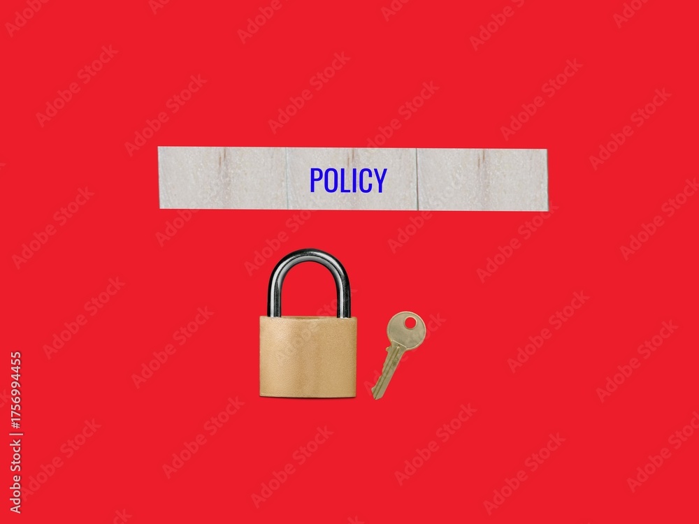 Policy text on card paper with a lock and key and a red background to ...