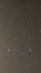 Wall Mural - Animation of light spots over white spots on black background