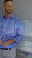 Wall Mural - Animation of financial graphs over diverse businesspeople working in office