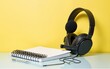 © Harper - Headphones with microphone and notebook on color background. High quality