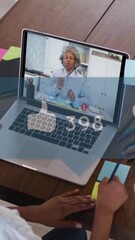 Wall Mural - Animation of social media icons over caucasian woman on laptop video call