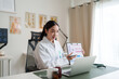 © Phimwilai - Female doctor presenting medical data during teleconsultation