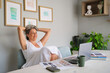 © Westend61 - Relaxed woman enjoying success and tranquility in home office