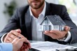© YouraPechkin - Real estate agent presents model house to client negotiating contract