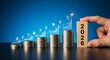 © Mohammad - A hand places a wooden block with the year 2026 on ascending stacks of coins, symbolizing financial growth and investment