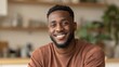 © Johannes - smiling cheerful young adult african american ethnicity man looking at camera standing at home office background happy confident black guy posing for headshot face front close up portrait no logos no