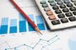 © manassanant - Calculator on chart graph paper. Finance, account, statistic, investment data economy, stock exchange business.