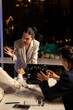 © Wasana - Analyzing stock market data, business people arguing during late night meeting