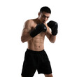 © Adobe Contributor - A muscular man in black boxing gloves is in a fighting stance, showcasing physical strength and athleticism.