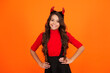 © be free - Trick or treat. All Hallows costume party celebration. All Hallows devil. Imp horns. Girl in Halloween imp costume. Happy Halloween. Girl devil in Halloween costume isolated on orange. Tiny devil