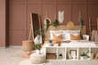 © Pixel-Shot - Comfortable bed, floor mirror and pouf near brown wall in interior of bedroom