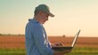 © Victoriia - Businessman with computer in hands works in wheat field, checking harvest. Farmer in field works with laptop. Agronomist works in field. Modern concept agricultural business. farmer analyzes harvest
