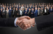 © New Africa - Partners shaking hands against crowd of business people on dark background. Banner design