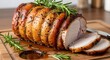 © Huzaifa - Roasted pork loin with rosemary on a wooden cutting board, showcasing its juicy and flavorful texture