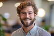 © Shikha Arts - Confident young man with a beard smiling in a modern office environment, showcasing his leadership and self-assurance while working on his professional goals, Generative AI