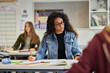 © Rido - Multiethnic female student focused on learning in classroom