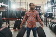 © Serhii - Smart African american male customer choosing new tires in the supermarket for buying. Big shopping mall with car goods
