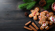 © Zerbor - A wooden table with a tray of gingerbread men and cinnamon sticks with copyspace