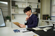 © Stella 16 - man holding clipboard with checklist employee workplace is reviewing documents in office