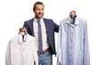 © Ljupco Smokovski - Man holding two shirts on hangers