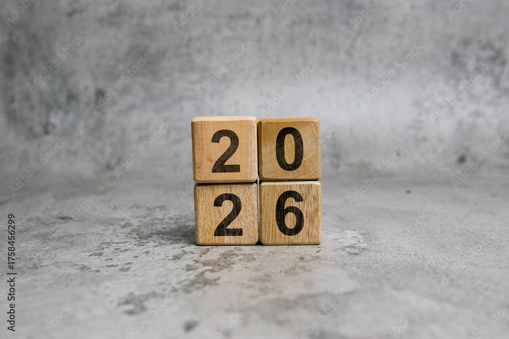 Wooden cube blocks with 2026 text on a gray background. New Year 2026 ...