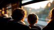 © Kateryna - Soft defocused silhouettes of family members sitting beside bright train window colorful luggage visible on overhead rack motion blur of countryside passing outside warm