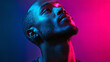 © Jeerawat - Dramatic Portrait of a Young Man with Colorful Neon Lighting