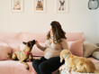 © Retamosa - Pregnant woman bonding with pet dogs at home
