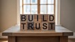 © NSF_Gallery - Wooden blocks spell out build trust on a table