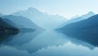 © Viktor - Mountain lake scenery with forest along waters edge. Calm lake reflects blue mountains landscape in fog. Nature water reflection and skyline. Perfect tranquil background for travel