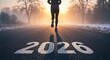 © Sergiy - A lone person jogs on a dark asphalt road marked with the year 2026, heading into a warm, foggy sunrise over a winter landscape.