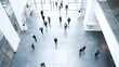 © Jojo* - People walking in a modern office building lobby with motion blur.