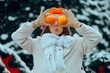 © nicoletaionescu - Cheerful Woman Holds Two Oranges in Front of Her Eyes. Lady boosting her immune system with vitamin c during wintertime