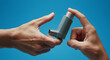 © MiniRiz - Essential Asthma Inhaler Usage: Hands Demonstrating Proper Technique for Effective Breathing Relief and Respiratory Management