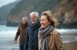 © Pete - Elderly couple walks along beach in winter with sea and cliffs. They are smiling and wearing warm clothes. Nature scene with ocean waves and rocky hillsides.