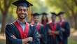© Maryna - Smiling Indian graduate in cap and gown stands proud. Friends blurred in soft focus background. Celebration of academic achievement at university. Student looks happy after graduation ceremony.