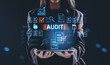 © ImageFlow - Businesswoman holding tablet with glowing audit hologram interface and digital document icons concept on dark background..