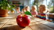 © Nataliya - Red apple rests on wooden table in school cafeteria, elementary students blurred in background, focusing on healthy eating, nourishment concepts, scene captures mealtime, education