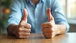 © miss irine - Man gives two thumbs up. Gesture signifies approval success good job. Person shows positive feedback. Agreement or like. Meeting or office setting.