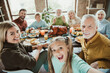 © deagreez - funny festive family feast selfie as generations gather for a warm thanksgiving dinner and joyful holiday celebration around the big table