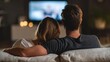 © Andrii  - Couple Relaxing on Couch Watching Movie