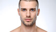 © homydesign - Headshot of a serious young man with blue eyes and short hair